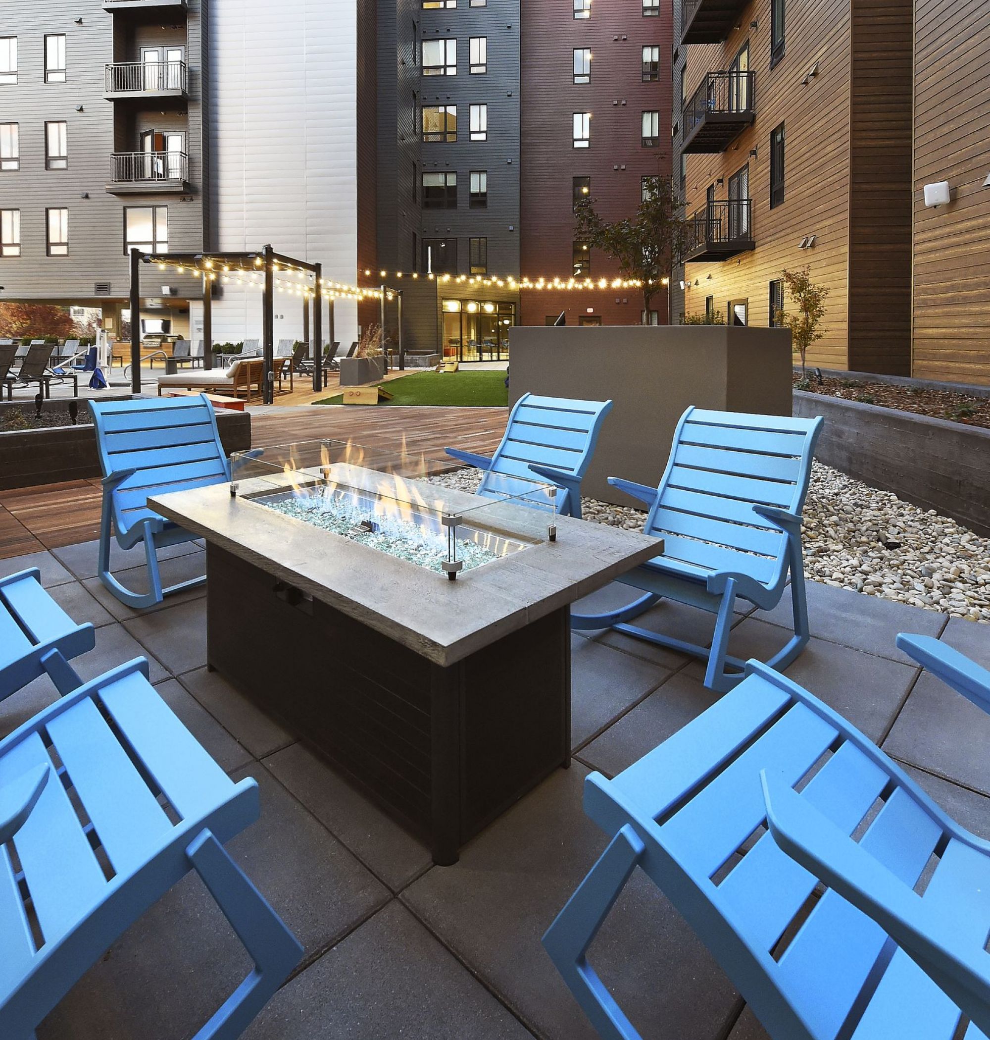 LOCAL Boise Apartments outdoor courtyard with fire pits, seating, and string lights