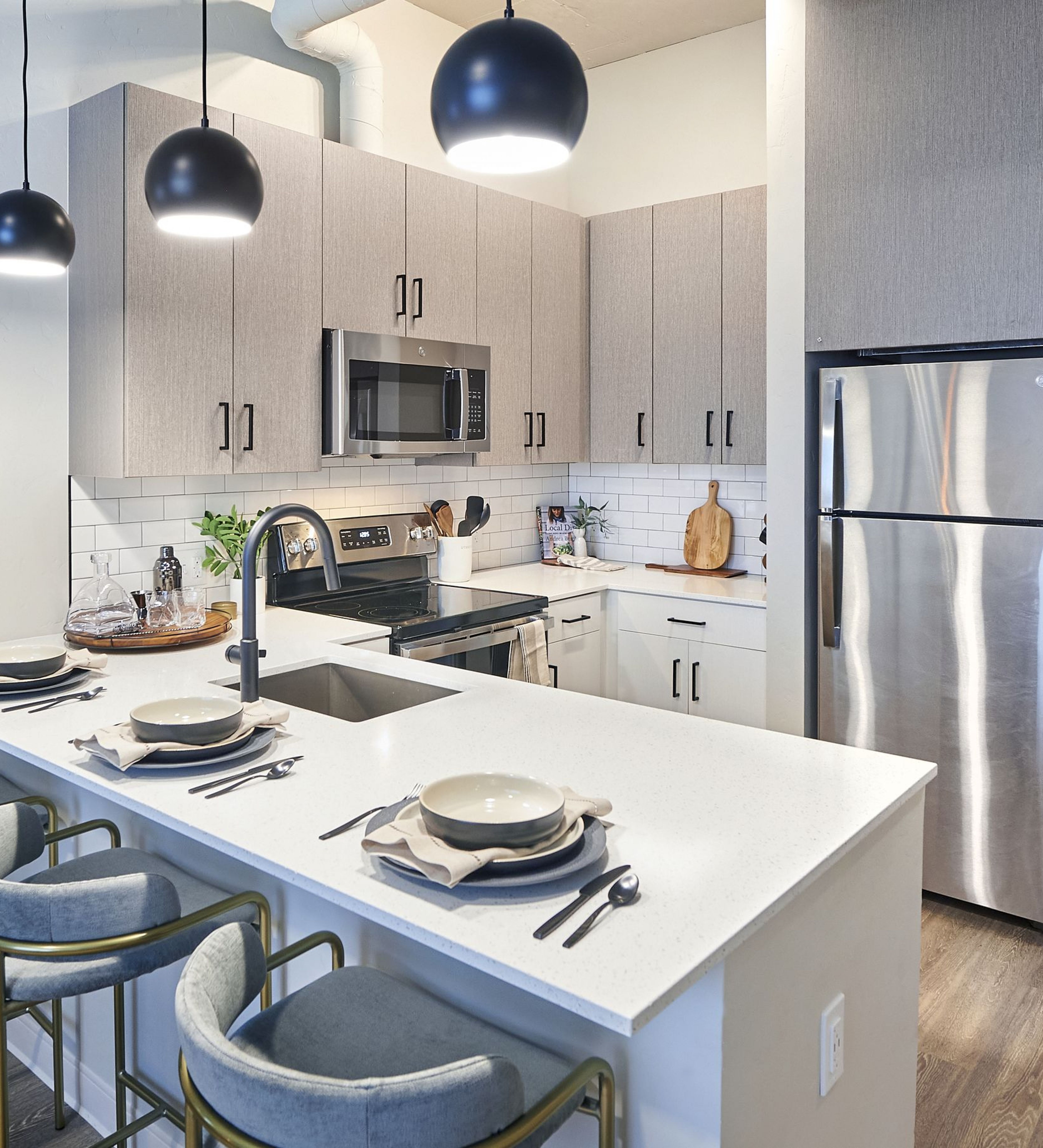 LOCAL Boise Apartments bright and spacious kitchen with stainless steel appliances, soft close designer cabinets, and quartz countertops