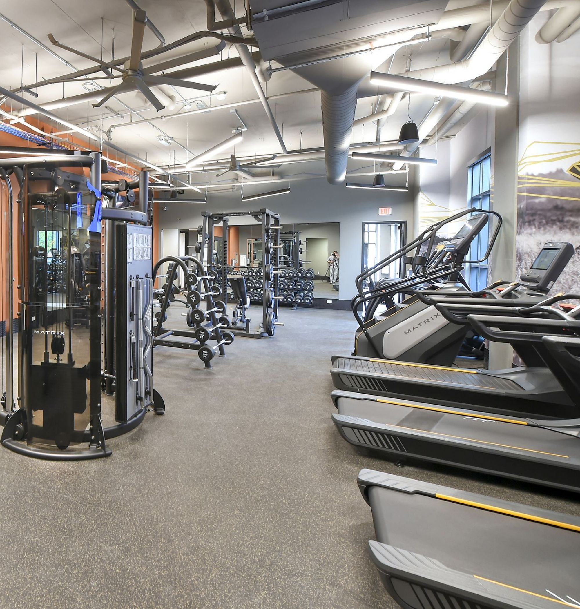LOCAL Boise Apartments bright and spacious fitness center with weight and cardio machines and free weights