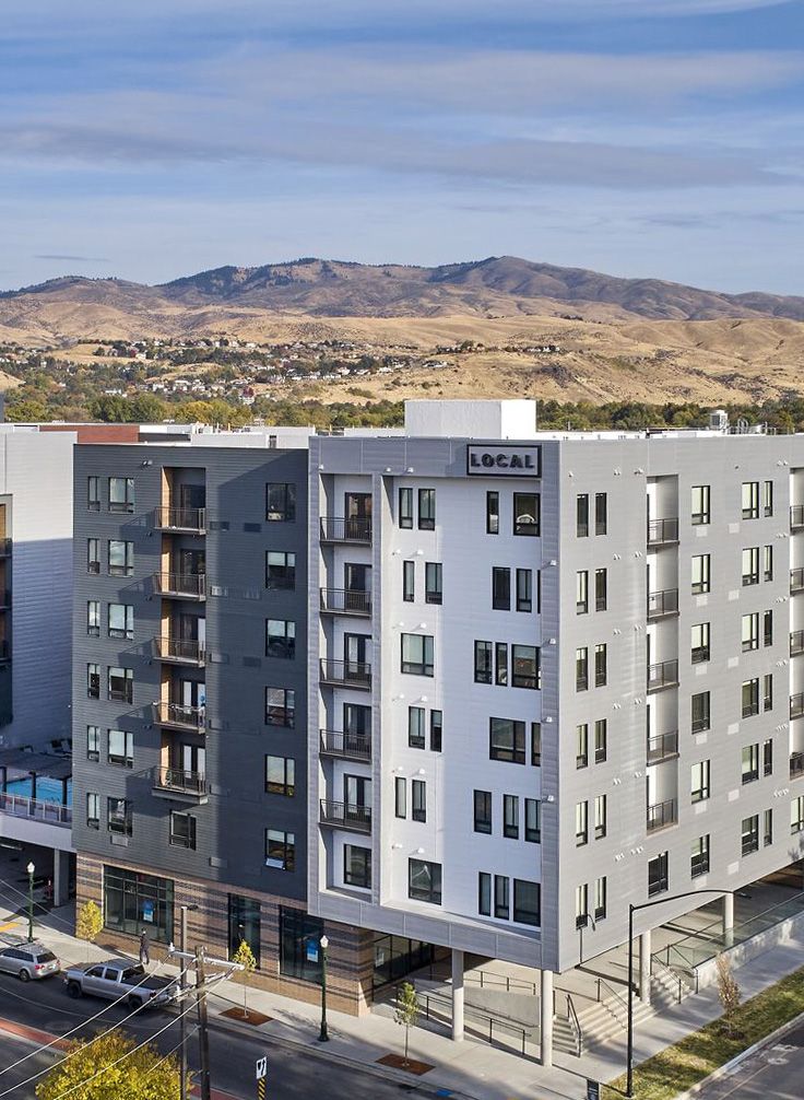 LOCAL Boise Apartments building exterior in Boise, Idaho with mountain landscape